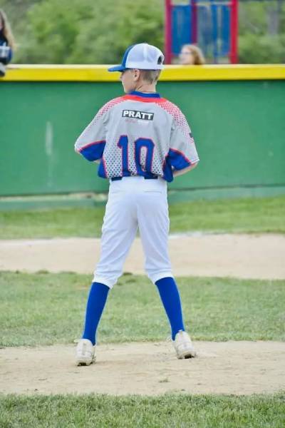 Player in a gray and blue jersey with number 10 standing on field.